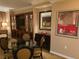 This dining area features a round glass table and four chairs near built-in storage and display cabinets at 135 E Harmon Ave # 2120, Las Vegas, NV 89109