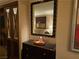 A stylish buffet features a decorative mirror and silver serving accessories, adding elegance to the dining space at 135 E Harmon Ave # 2120, Las Vegas, NV 89109