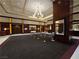 Spacious lobby with elegant chandelier and comfortable seating area and concierge stand at 135 E Harmon Ave # 2120, Las Vegas, NV 89109