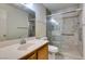 Bathroom with vanity, toilet, and tiled shower with glass door at 1412 Oak Rock Dr # 202, Las Vegas, NV 89128