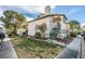 A condo building with a well-kept lawn, mature trees, and a private staircase leading to the upper units at 1412 Oak Rock Dr # 202, Las Vegas, NV 89128