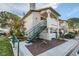 Two-story condo featuring a private entry staircase, desert landscaping, and a well-maintained facade at 1412 Oak Rock Dr # 202, Las Vegas, NV 89128