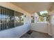 A condo front porch with security door, windows with blinds, and views of the neighborhood street at 1412 Oak Rock Dr # 202, Las Vegas, NV 89128