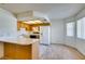 Bright kitchen featuring wood cabinets, laminate countertops, and wood-look flooring at 1412 Oak Rock Dr # 202, Las Vegas, NV 89128
