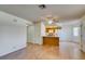 Open living room flows into the kitchen, featuring wood floors, natural light and white cabinets at 1412 Oak Rock Dr # 202, Las Vegas, NV 89128