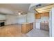 Open concept living room with kitchen, featuring wood floors, a fireplace, and white appliances at 1412 Oak Rock Dr # 202, Las Vegas, NV 89128