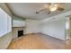 Open living area with a decorative stone fireplace, and wood-look floors at 1412 Oak Rock Dr # 202, Las Vegas, NV 89128