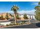 Neighborhood street view with desert landscaping, and a mountain backdrop on a sunny day at 1412 Oak Rock Dr # 202, Las Vegas, NV 89128