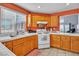 Kitchen area featuring wooden cabinets, light countertops, and natural lighting at 1453 Blisworth Ct # 102, Las Vegas, NV 89102