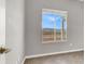 Bedroom showcasing bright window with scenic view, neutral paint, and tile flooring at 1551 Dusty Canyon St, Henderson, NV 89052