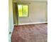 Carpeted bedroom with neutral-colored walls and bright windows at 1915 Hazeltine Ct, Henderson, NV 89074