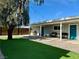 Charming backyard features artificial turf, a mature shade tree and covered patios for outdoor enjoyment at 2250 Red Rock St, Las Vegas, NV 89146