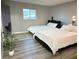 Bedroom features two beds with white linens, a plant, a window, and vinyl floors at 2250 Red Rock St, Las Vegas, NV 89146