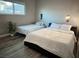 Bright bedroom features two beds with white linens, a plant, and a window at 2250 Red Rock St, Las Vegas, NV 89146