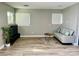 Bright living room features a modern sofa, tv, and wood-look flooring at 2250 Red Rock St, Las Vegas, NV 89146