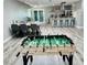 Open-concept living area with dining table, and a kitchen with barstool seating and a foosball table at 2250 Red Rock St, Las Vegas, NV 89146