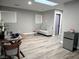 Living room features a table, a sofa, a mini fridge, and wood-look flooring at 2250 Red Rock St, Las Vegas, NV 89146