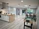 Spacious open-concept living area featuring a modern kitchen, dining space, and recreation area with a foosball table at 2250 Red Rock St, Las Vegas, NV 89146