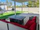 Comfortable patio area features ample seating, a dining table, and backyard access with artificial turf at 2250 Red Rock St, Las Vegas, NV 89146
