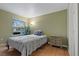 Bedroom with a large window, hardwood flooring, and a closet with a door at 2300 E Silverado Ranch Blvd # 1059, Las Vegas, NV 89183