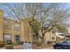 Beige stucco home with mature tree landscaping, car parking, and green grass at 2300 E Silverado Ranch Blvd # 1059, Las Vegas, NV 89183