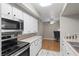 White cabinets, stainless steel appliances, and breakfast bar overlooking adjacent dining space at 2300 E Silverado Ranch Blvd # 1059, Las Vegas, NV 89183