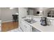 Kitchen area with breakfast bar, stainless steel sink and white countertops at 2300 E Silverado Ranch Blvd # 1059, Las Vegas, NV 89183
