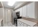 Close-up of kitchen highlighting white cabinets, stainless steel appliances and tile flooring at 2300 E Silverado Ranch Blvd # 1059, Las Vegas, NV 89183