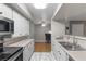 Kitchen showcasing white cabinets, stainless steel appliances, and breakfast bar at 2300 E Silverado Ranch Blvd # 1059, Las Vegas, NV 89183