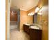 Bathroom featuring double sink granite vanity and large soaking tub with tile surround at 2405 Serene Ave # 241, Las Vegas, NV 89123