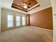 Spacious bedroom with tray ceiling, fan, and a large window with plantation shutters at 2405 Serene Ave # 241, Las Vegas, NV 89123