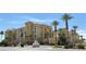 Expansive view of a luxury apartment building with desert landscaping and beautiful palm trees at 2405 Serene Ave # 241, Las Vegas, NV 89123