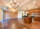 Open concept living area and kitchen with wooden floors, granite countertops, and stainless appliances at 2405 Serene Ave # 241, Las Vegas, NV 89123