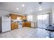 Bright kitchen with tile floors, wooden cabinets, and a sliding door to the backyard at 320 Ellen Marie Dr, Las Vegas, NV 89110