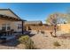 Spacious backyard featuring a covered patio, desert landscaping, and complete privacy at 3924 E Garfield Dr, Pahrump, NV 89061