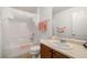 Well-lit bathroom with a single sink vanity, tiled floors, and a shower-tub combination with white tile surround at 3924 E Garfield Dr, Pahrump, NV 89061