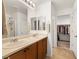 Bathroom with double sinks, neutral walls and access to a walk-in closet at 3924 E Garfield Dr, Pahrump, NV 89061