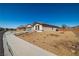 Desert-landscaped single-story home with a two-car garage, set against a clear blue sky in a neighborhood setting at 3924 E Garfield Dr, Pahrump, NV 89061