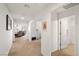 Bright hallway featuring carpeted floors and fresh paint, connecting to a living area and a bathroom at 3924 E Garfield Dr, Pahrump, NV 89061