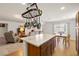 Open-concept layout with a kitchen island that flows into living and dining areas at 3924 E Garfield Dr, Pahrump, NV 89061