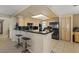 Kitchen with breakfast bar, tile floors, black appliances, and granite countertops at 399 Placer Creek Ln, Henderson, NV 89014