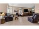 Living room featuring tile flooring, window shutters, and comfortable seating at 399 Placer Creek Ln, Henderson, NV 89014