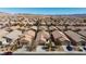 An aerial view showcasing a vast neighborhood with desert landscaping and mountain views at 4012 Shetland Pony St, Las Vegas, NV 89122