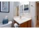 Bathroom with a wood vanity, mirror, and open door at 4012 Shetland Pony St, Las Vegas, NV 89122