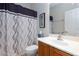 Well-lit bathroom with a modern vanity and stylish shower curtain at 4012 Shetland Pony St, Las Vegas, NV 89122