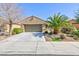 Charming stucco home featuring mature landscaping, a two-car garage, and a paved driveway at 4012 Shetland Pony St, Las Vegas, NV 89122