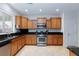 Well-lit kitchen featuring stainless steel appliances and granite countertops at 4012 Shetland Pony St, Las Vegas, NV 89122