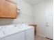 Bright laundry room with modern washer and dryer, shelving, and tile flooring at 4012 Shetland Pony St, Las Vegas, NV 89122