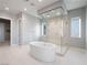 Modern bathroom featuring a standalone tub and large glass shower at 4880 Argento Peak St, Las Vegas, NV 89135