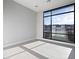 Bright bedroom with large modern window and tile flooring, offering a view of the surrounding landscape at 4880 Argento Peak St, Las Vegas, NV 89135